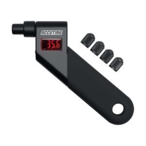A person uses a digital tire pressure gauge on a car tire outdoors.