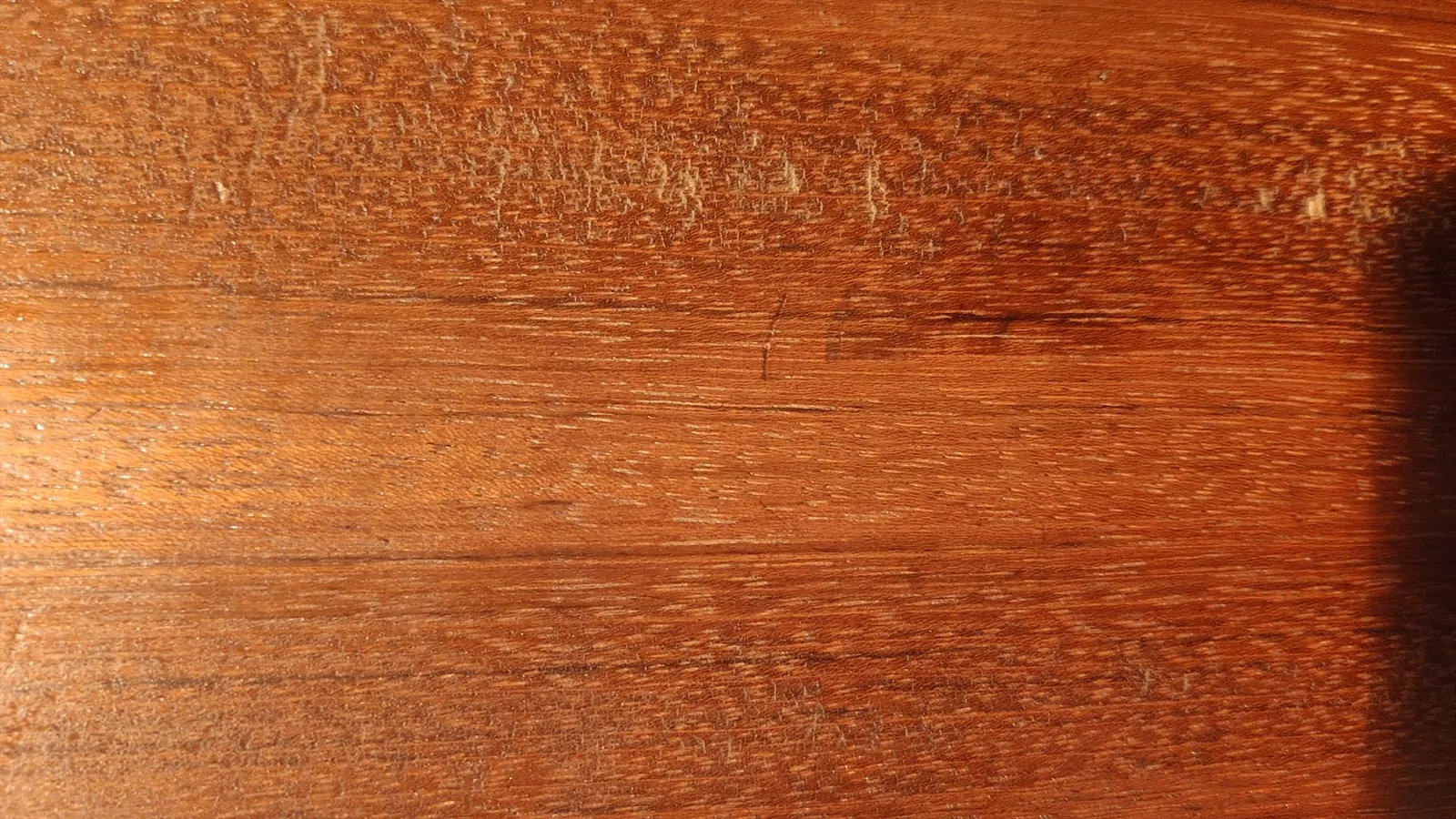 Cleaning the surface of raw Jatoba wood with a solvent before finishing.