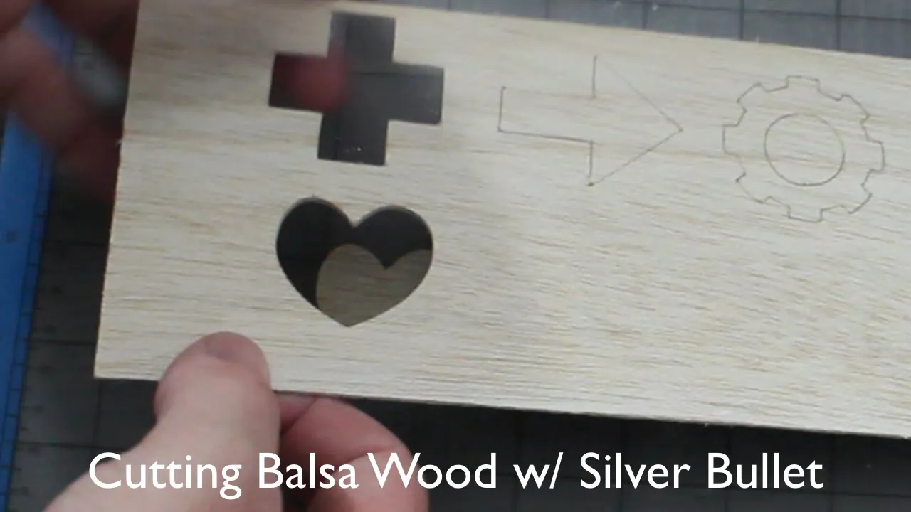 Close up of balsa wood grain texture with a craft knife blade positioned.