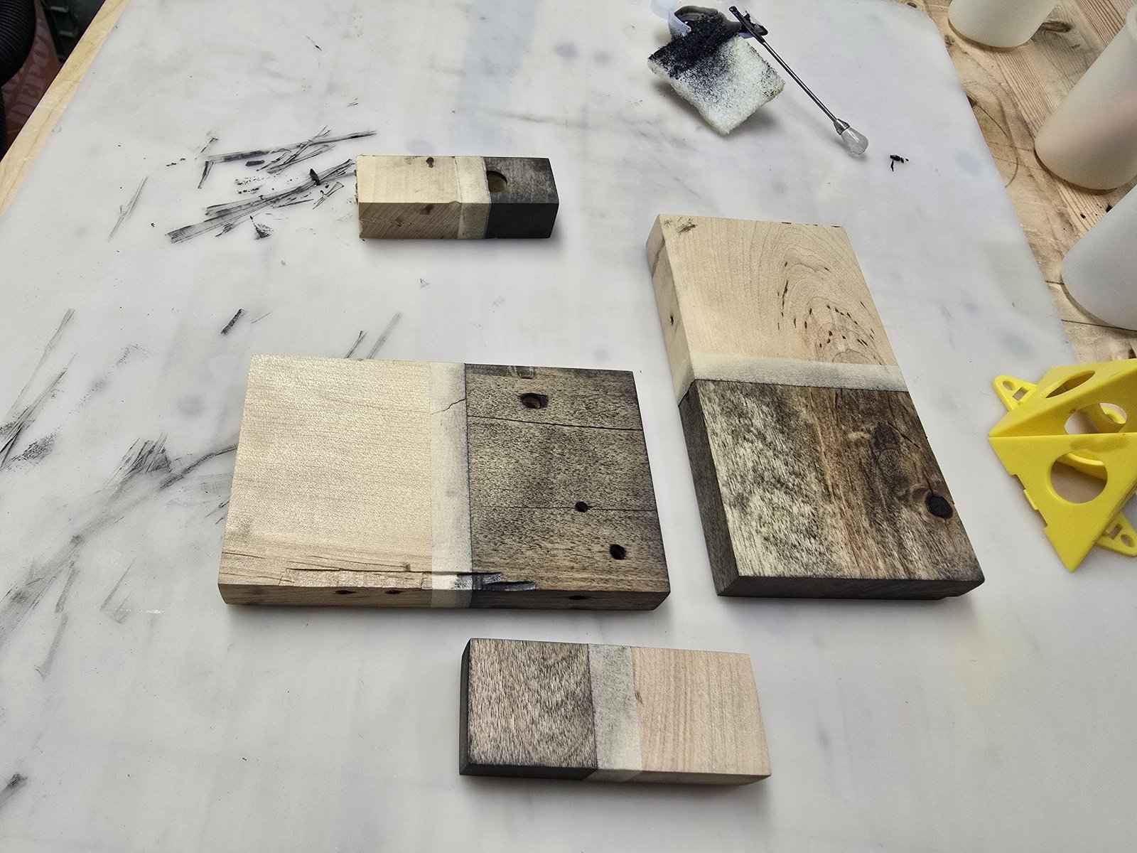 Essential supplies for using mineral spirits on wood arranged neatly on a workbench.