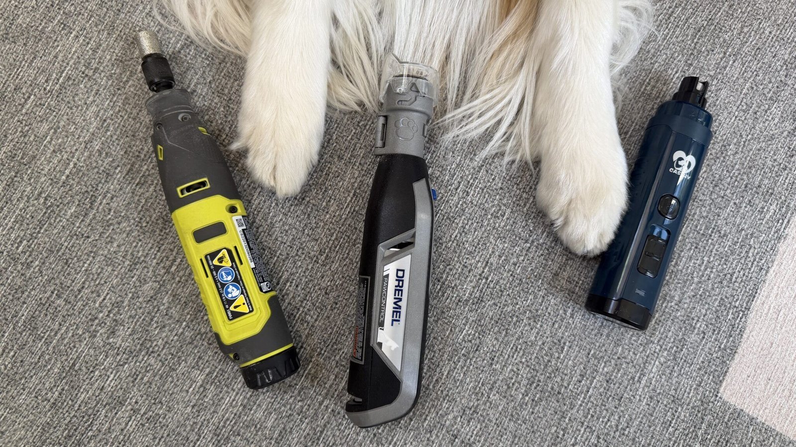 Essential tools for making a rotary tool quieter arranged on a wooden workbench.