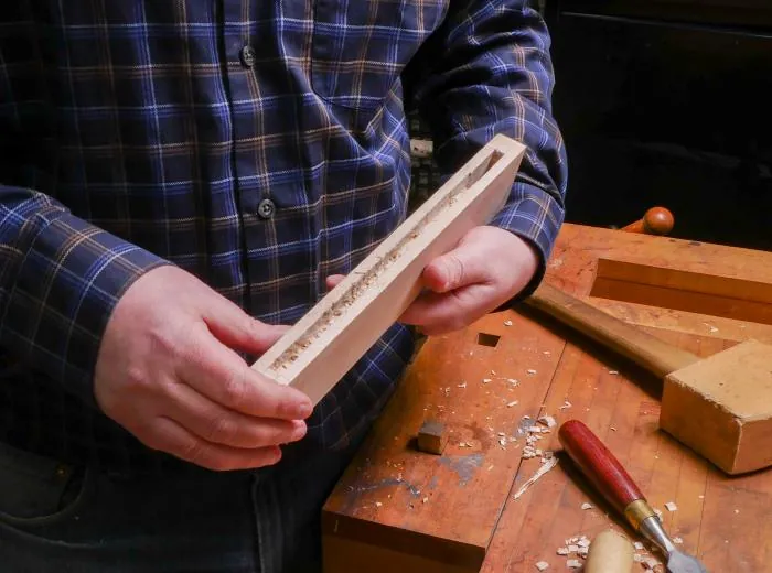 Essential woodworking tools used for cutting grooves into wood in a workshop setting.