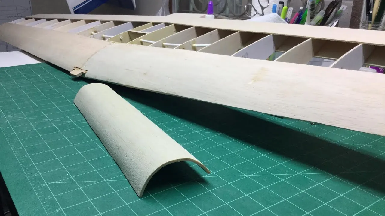 Glue is applied to a balsa wood joint during a model building project.