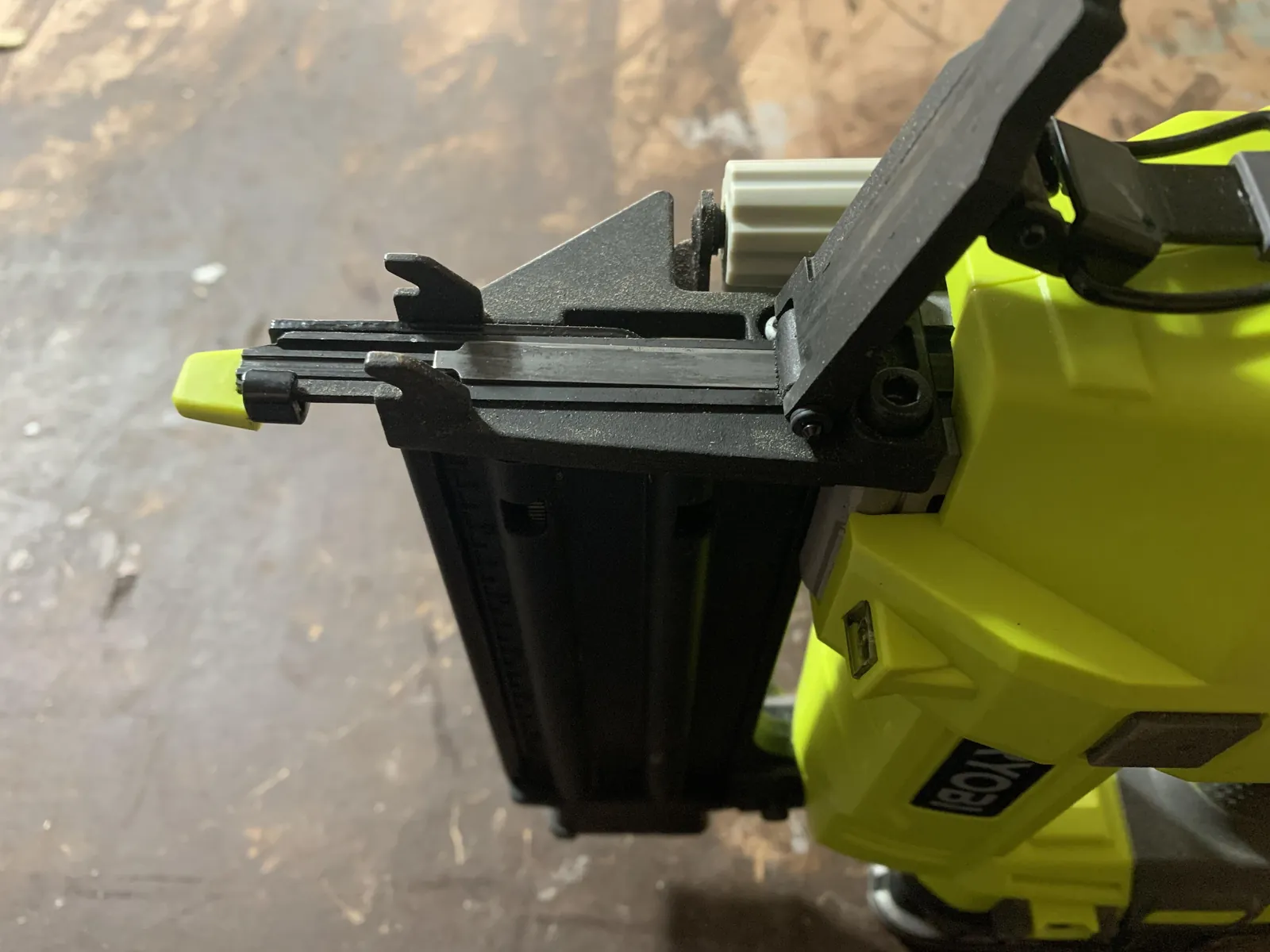 Loading a nail gun with the correct size of fasteners.