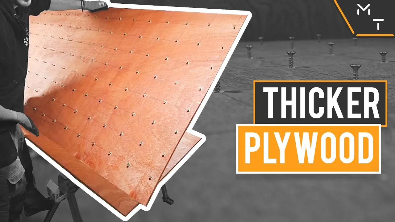 Multiple layers of plywood are clamped together on a workbench for lamination.