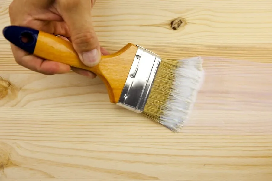 Oil-based and water-based polyurethane finishes compared side-by-side on wooden sample boards.