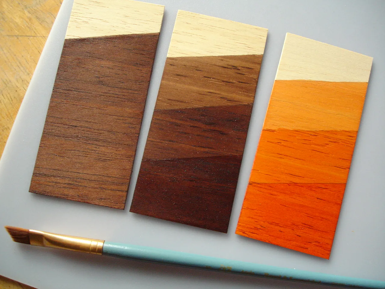 Preparation tools and supplies for staining balsa wood arranged on a surface.