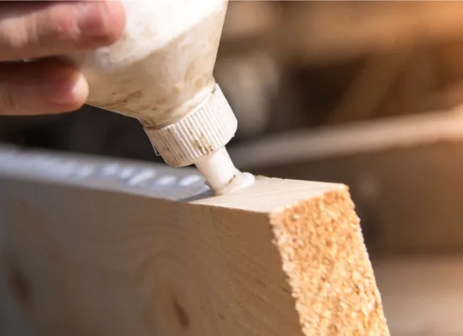 Preparing two-part epoxy to bond wood and metal surfaces together.