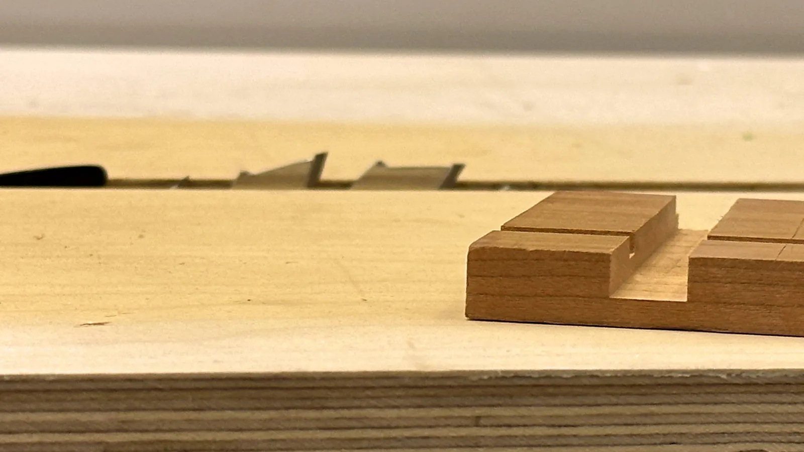 A professional router sits near intricate furniture, illustrating better alternatives for precise joints.