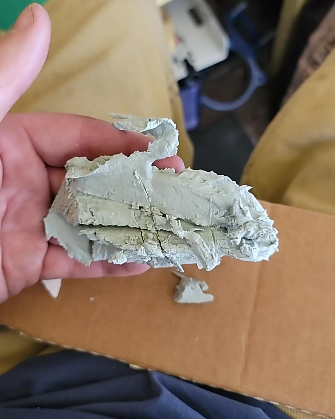 Properly mixed automotive filler on a plastic board for an accurate repair.