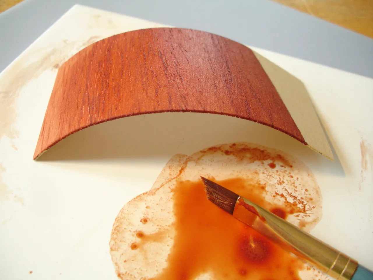 Repairing a dent in balsa wood using a damp cloth and iron.