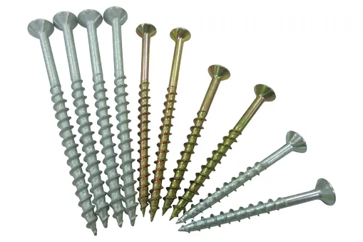 The sharp tip of a self-tapping screw touching the surface of pine wood.