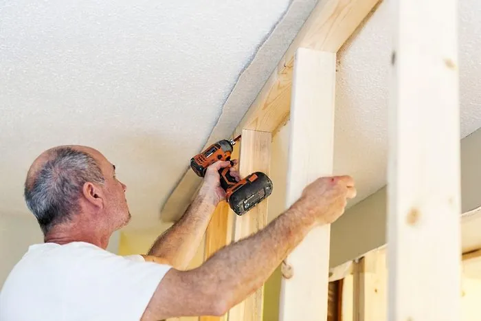 A single screw hole in a wall showing careful stud maintenance.