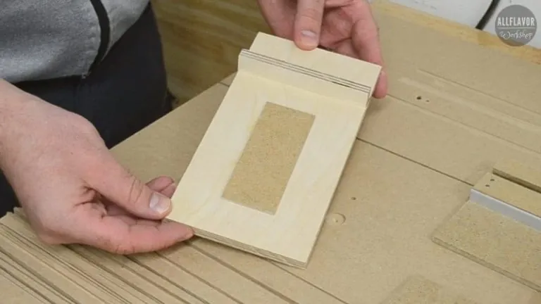 A specialized CNC machine bit positioned over a curved piece of wood.