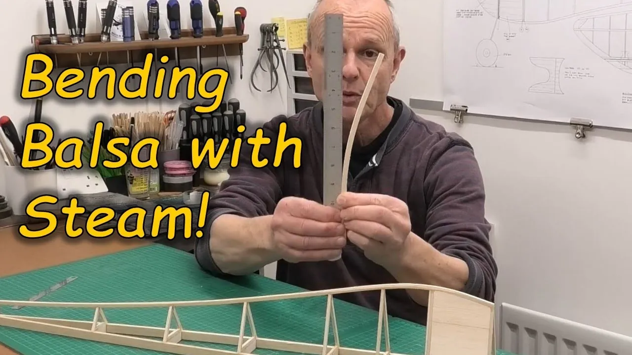 Two pieces of balsa wood are prepared for the bending process on a desk.