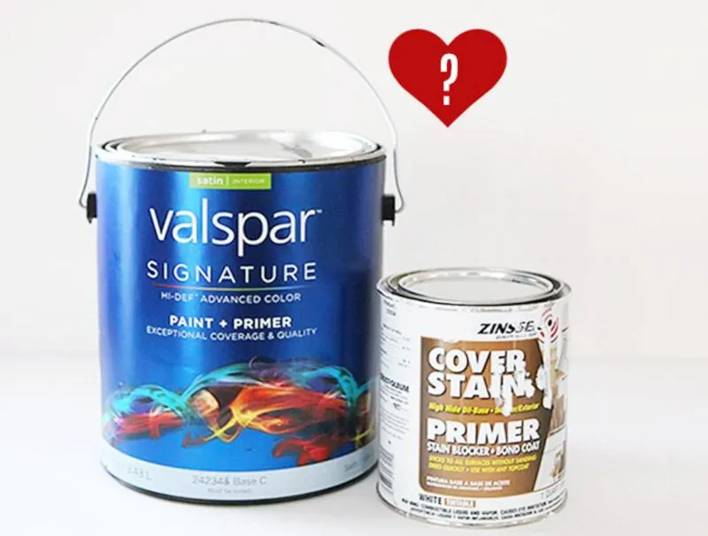 Various cans of primer displayed on a workbench for choosing the right product.
