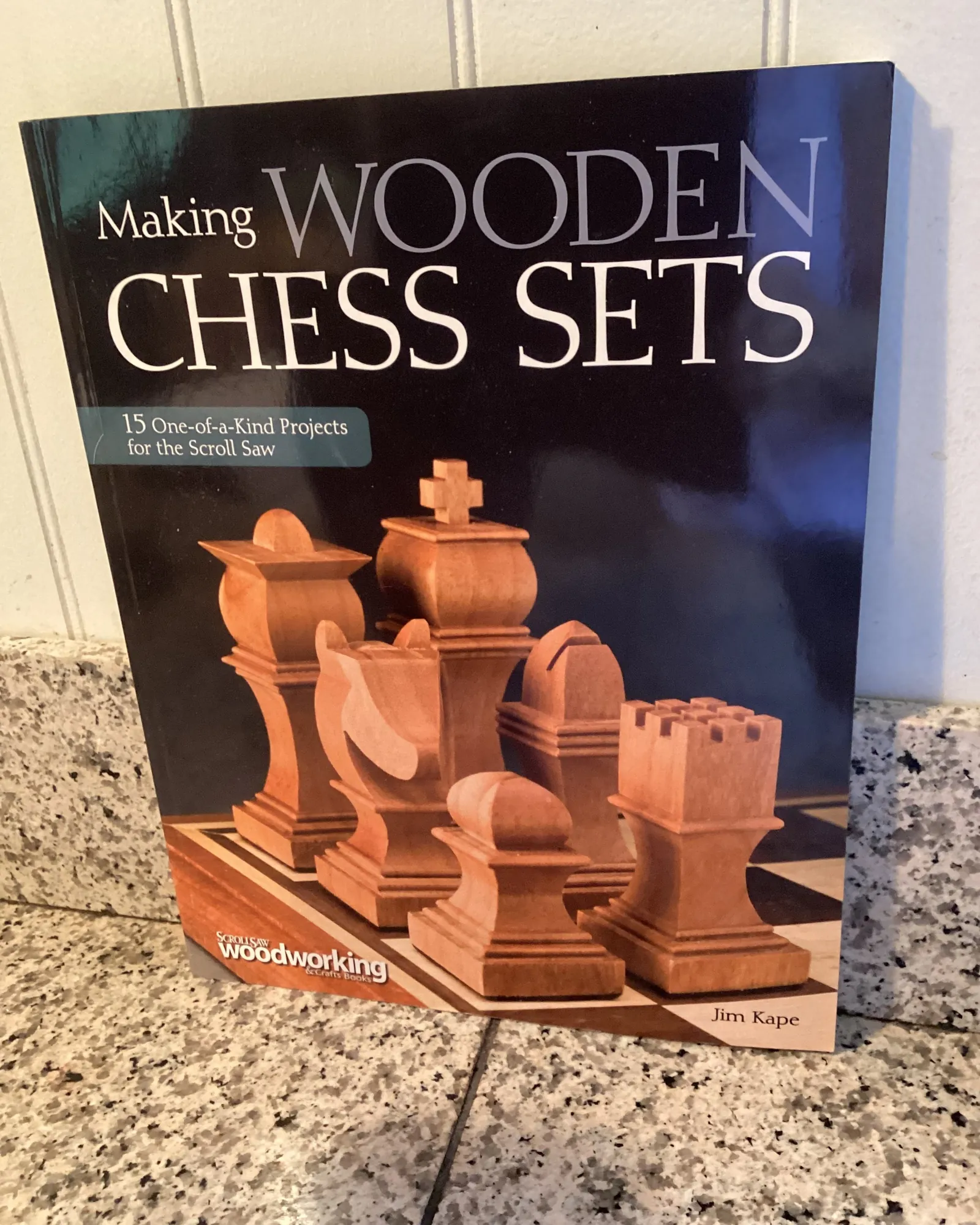 Wooden chess pieces being maintained with oil on a workbench.