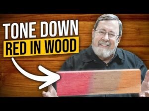 A wooden table shows the transition from reddish wood to neutralized brown wood.